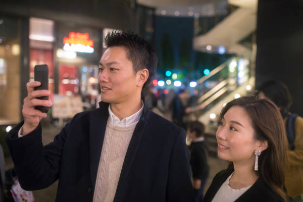 istock Young husband taking picture with smart photn 889592096