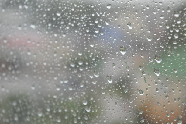 istock Drops of rain on the window, rainy day 889592258
