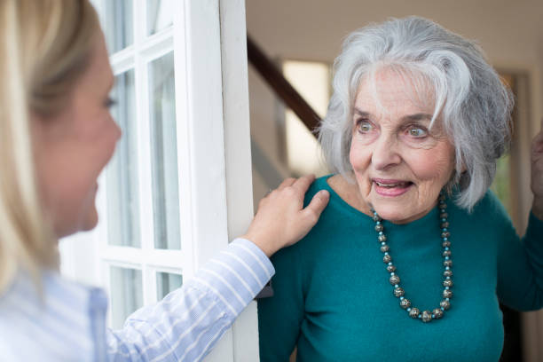 istock Woman Checking On Elderly Female Neighbor 889592584