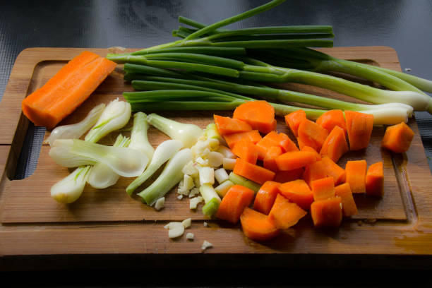 istock Carrots and Spring Onions on Cutting Board 889598368