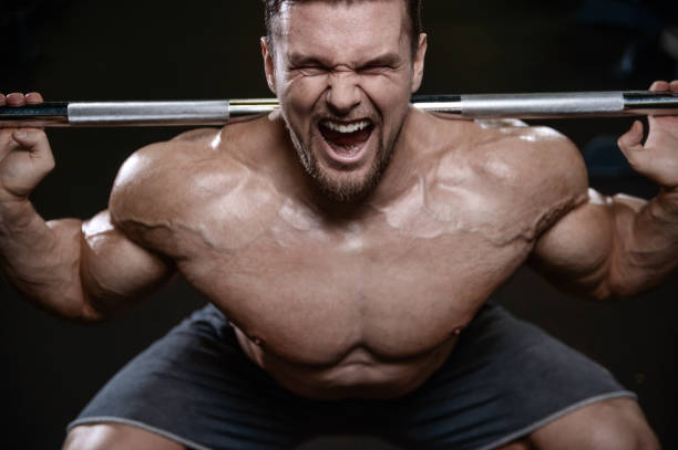 istock Brutal strong bodybuilder athletic men pumping up muscles with dumbbells 889602644