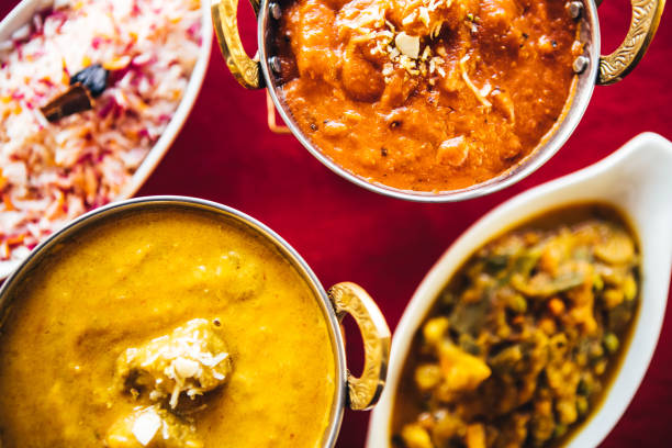 istock Butter chicken, lamb curry, vegetable curry and basmati rice on a table. North Indian food 889603110
