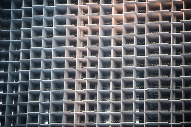 Facade of unfinished building in the process of construction. The symbol of monotony of apartmentsFacade of unfinished building in the process of construction. The symbol of monotony of apartments