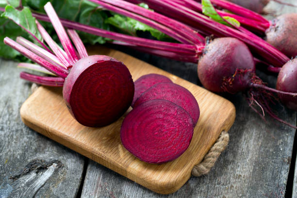 fresh sliced beetroot on wooden surface stock photo
