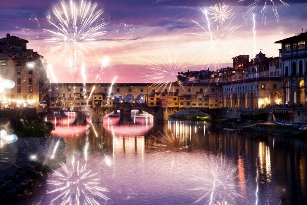 istock celebrating New year's eve in Florence, Italy - explosive fireworks around ponte vecchio on river arno 889606768