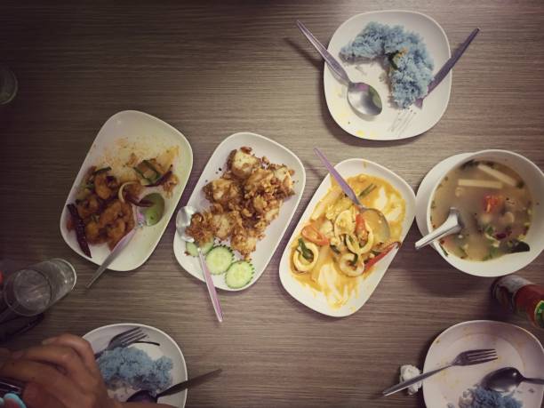 istock Assorted Thai food set. Stir-Fried Chicken with Cashew Nuts, Stir fried squid with salted egg, hot and spicy pork rib with Thai herbs on the table, vintage tone & still life style. Top view 889609706