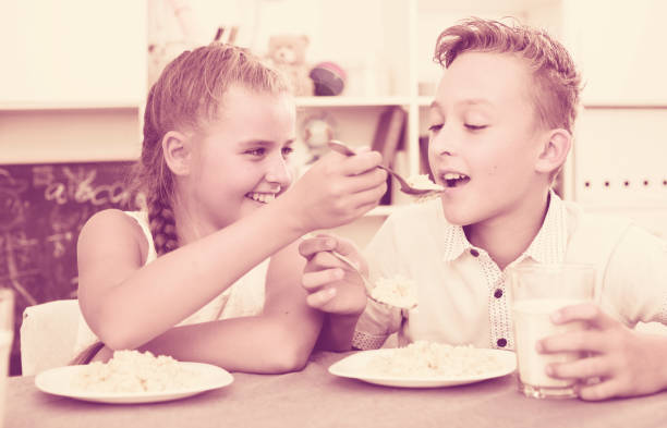 istock Sister with brother are playing with food 889615930