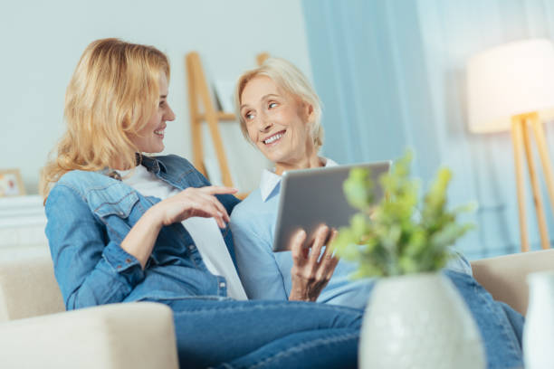 istock Cheerful relatives sitting on a sofa and communicating with each other 889618726