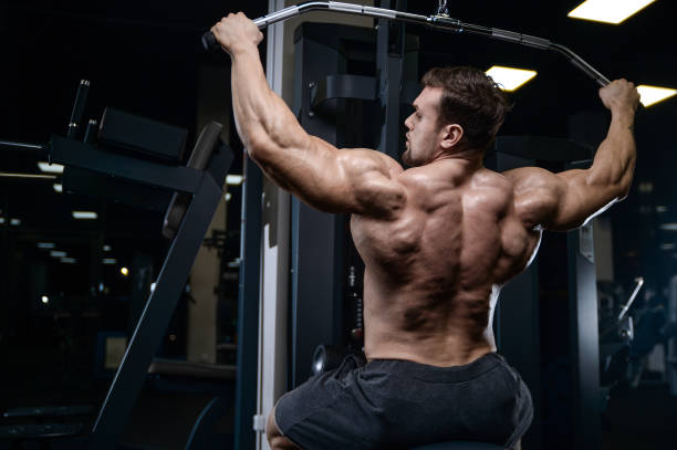 istock Brutal strong bodybuilder athletic men pumping up muscles with dumbbells 889624138