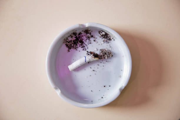 istock Cigarette cigarette butts in an ashtray . Abstract cigarette butt cigarette on litter bin outside a business premises 889624210