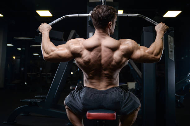 istock Brutal strong bodybuilder athletic men pumping up muscles with dumbbells 889626776