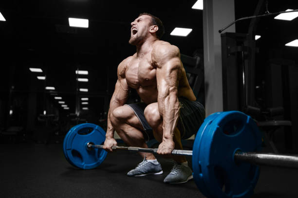 istock Brutal strong bodybuilder athletic men pumping up muscles with dumbbells 889626930