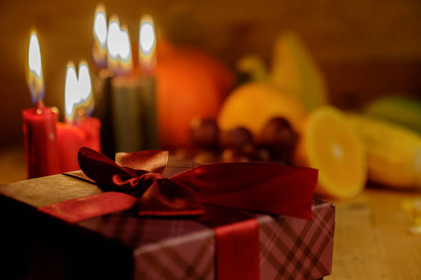 Kwanzaa holiday concept with decorate seven candles red, black and green, gift box, pumpkin,corn and fruit on wooden desk and background. Kwanzaa holiday concept with decorate seven candles red, black and green, gift box, pumpkin,corn and fruit on wooden desk and background. kwanzaa stock pictures, royalty-free photos & images