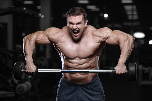 istock Brutal strong bodybuilder athletic men pumping up muscles with dumbbells 889632888