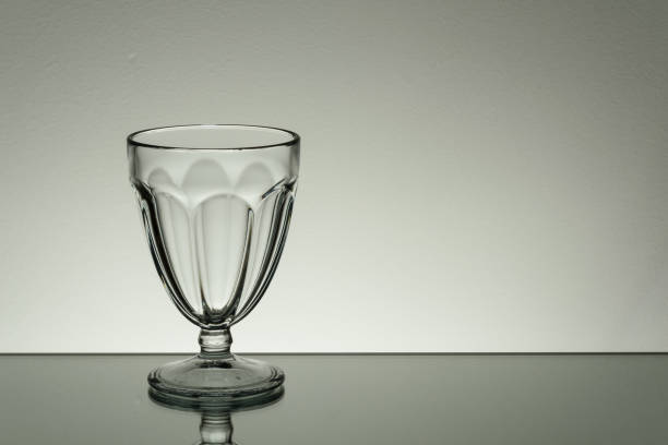 Glass on mirror and black background illuminated