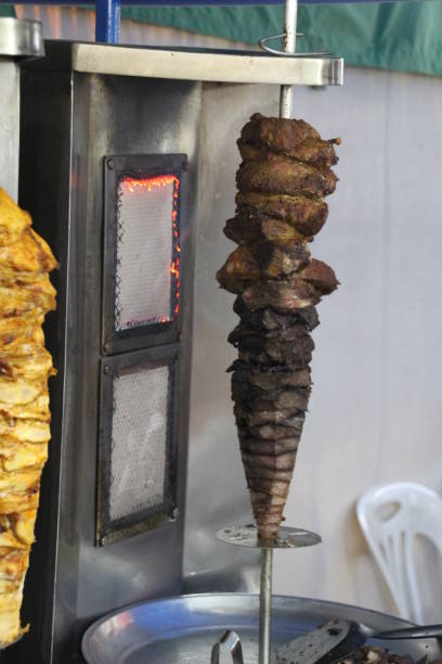 istock Doner Kebab meat roasting on a spit 889642424