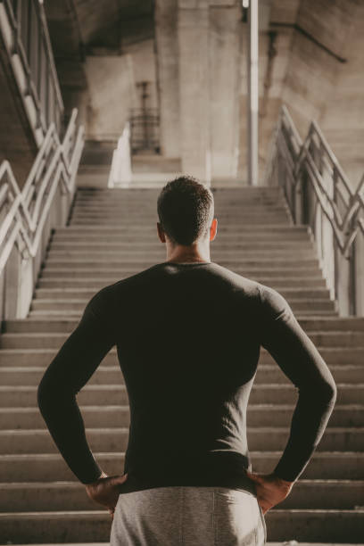 hombre joven preparándose para el entrenamiento - staircase running moving up jogging fotografías e imágenes de stock