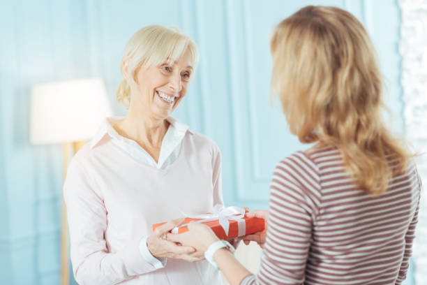 istock Cheerful emotional pensioner getting a nice present from the relative 889654270