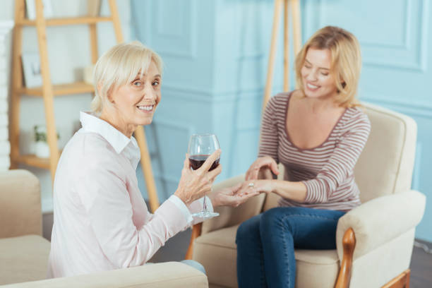 istock Positive aged woman drinking wine and admiring a beautiful ring 889655034