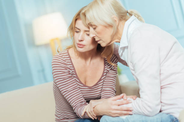 istock Kind attentive pensioner hugging and supporting her granddaughter 889660696