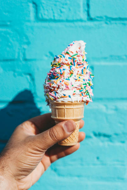 istock Holding ice cream against blue wall 889667008