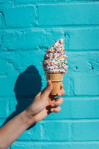 istock Holding ice cream against blue wall 889667020