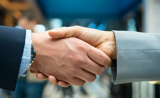 Business handshake isolated on white background