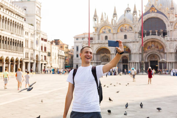 istock Man makes selfi in the Plaza San Marco in Venice 889684804