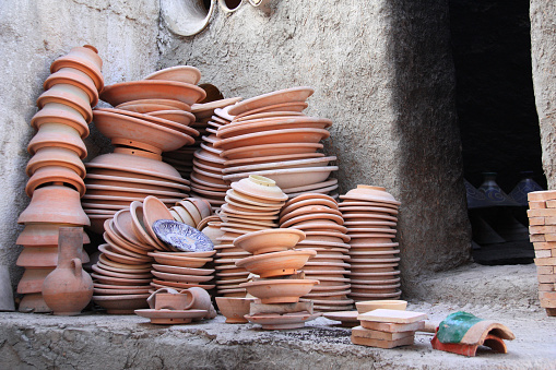 Preparing clay pottery for firing in adobe furnace. Traditional moroccan berber craft, Fez, Morocco, North Africa