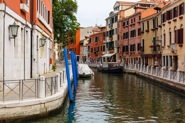 boats in a narrow canal of venice - venice italy veneto architecture blue imagens e fotografias de stock