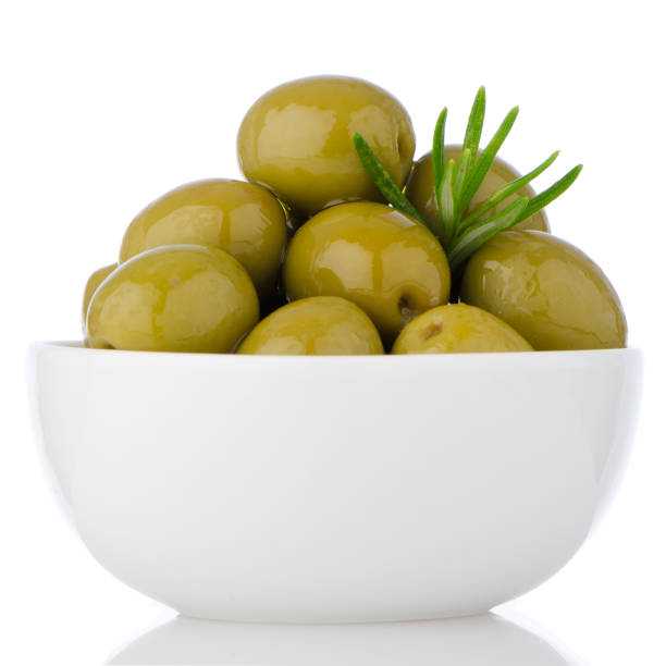 istock Green olives in a white ceramic bowl 889720500