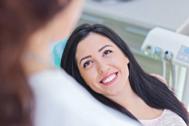 istock Happy woman at dentist office 889720572