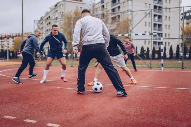 istock Men playing football 889727848