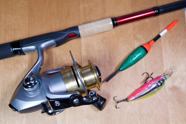 istock Fishing tackle, coil, float and baits on a wooden background 889730908