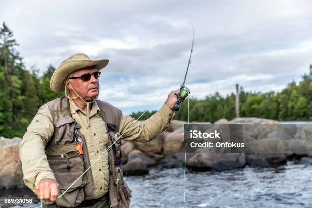 Senior Man Fisherman Fly Fishing In A River Stock Photo - Download Image Now - 65-69 Years, Active Lifestyle, Active Seniors