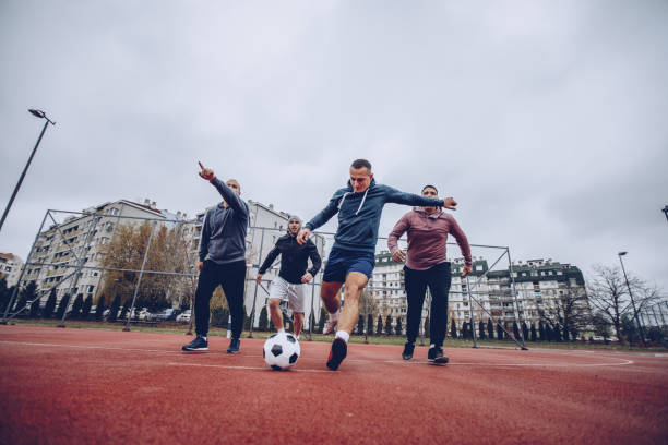 istock Guys playing football 889733734