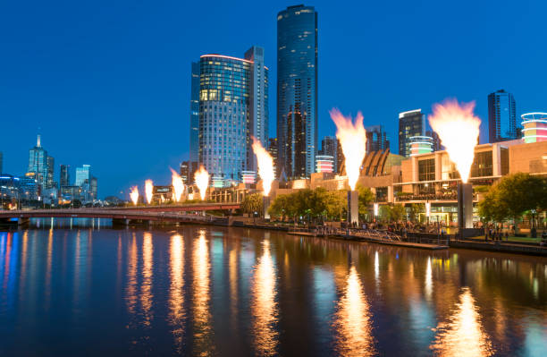 The famous fire show in front of the Melbourne skyline at sunset by the beautiful Yarra River. Melbourne, Australia.