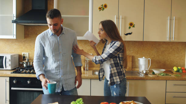 istock Young couple quarrels in the kitchen at home 889740734