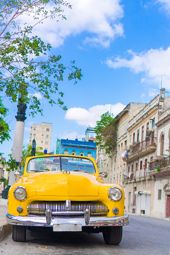 View of yellow classic vintage car in Old Havana, Cuba