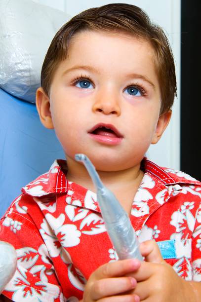 istock Little kid in a dentist chair 889748624