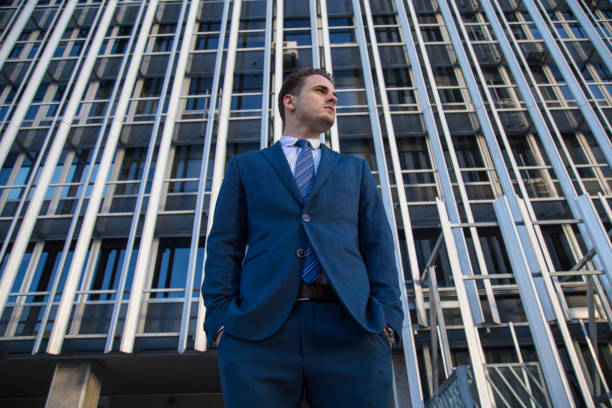 istock Confident businessman on urban background 889748730