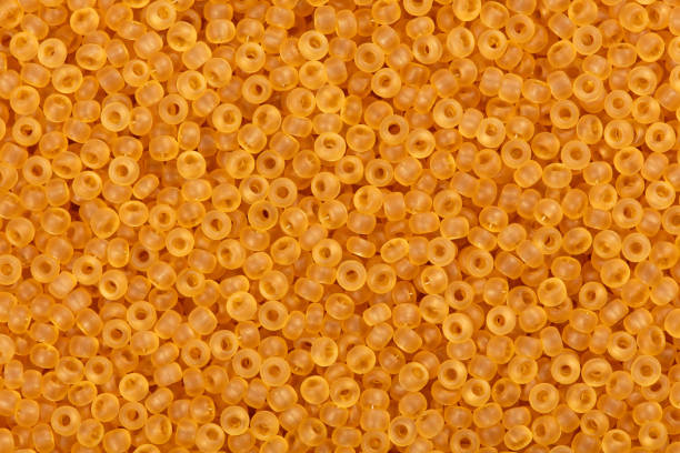 istock Close up of orange seed beads 889749532