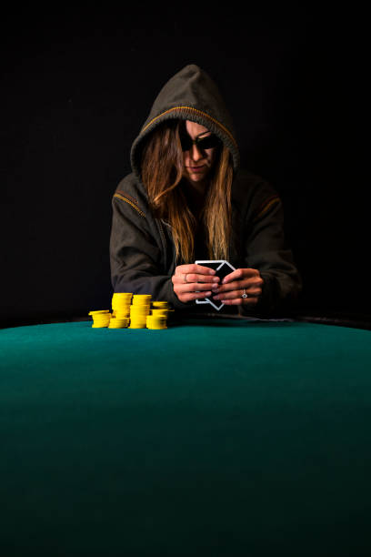 istock Woman Poker Player Looking at her Cards 889752006