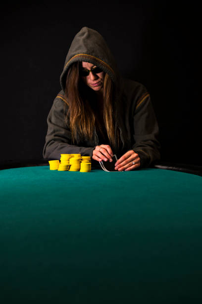 istock Woman Poker Player Looking at her Cards 889752084