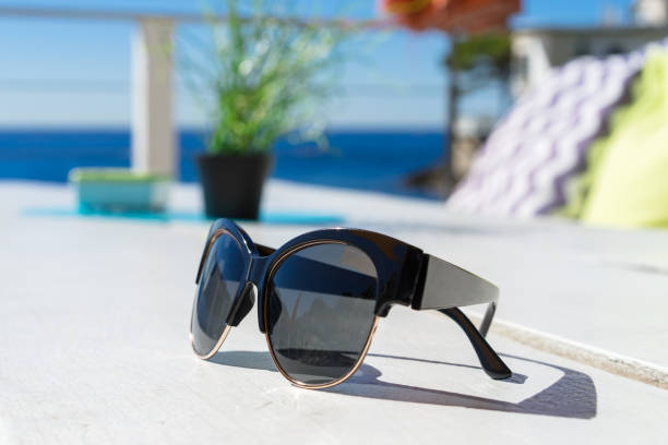 istock sunglasses on the table sea in beach cafe 889759096