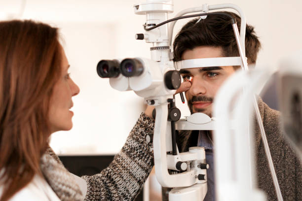 istock Young man having his eyes examined 889763730