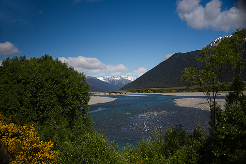 Waterfall and meltwater river in the valley approaching Briksdal Glacier in Norway.