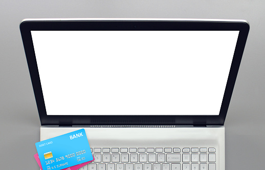 A blank laptop screen with some fictional cards demonstrating online payment.
