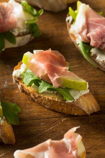 istock Homemade Prosciutto Pear Cheese Crostini 889777714