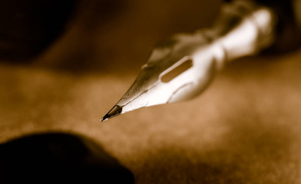 Close-up do bico da caneta no papel pergaminho - foto de acervo